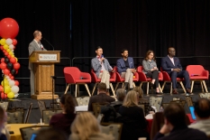 Panelists on stage at the Summit